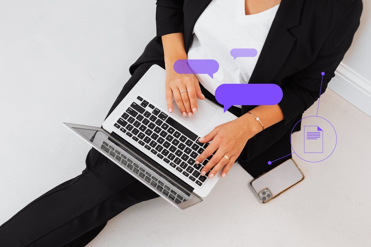High-angle shot of a woman in black suit using a laptop, symbolizing digital communication.